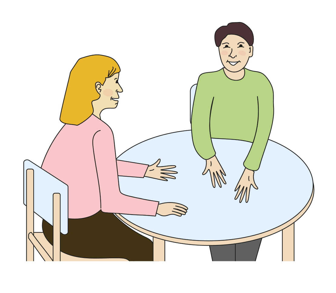 Ein Jugendlicher und eine Beraterin sitzen am Tisch. Sie reden miteinander.